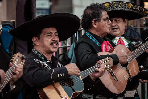 men in hats playing guitars