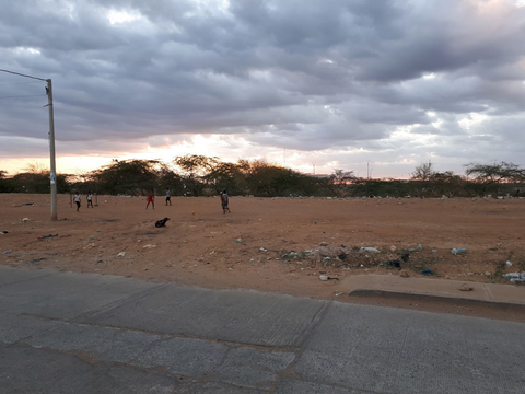 people playing soccer on field in uribia