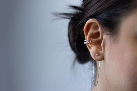 Girl-with-her-hair-up-showing-multiple-ear-piercings-after-using-piercing-bump-treatment-oil