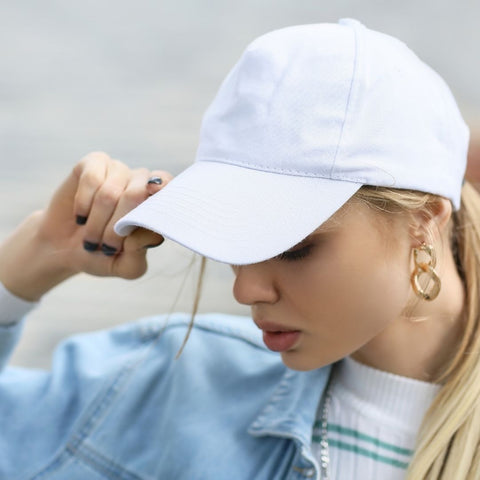 woman wearing white baseball hat