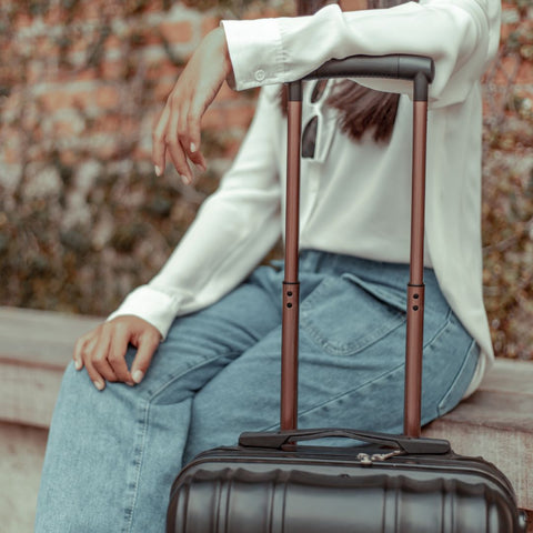 woman sitting with her luggage case