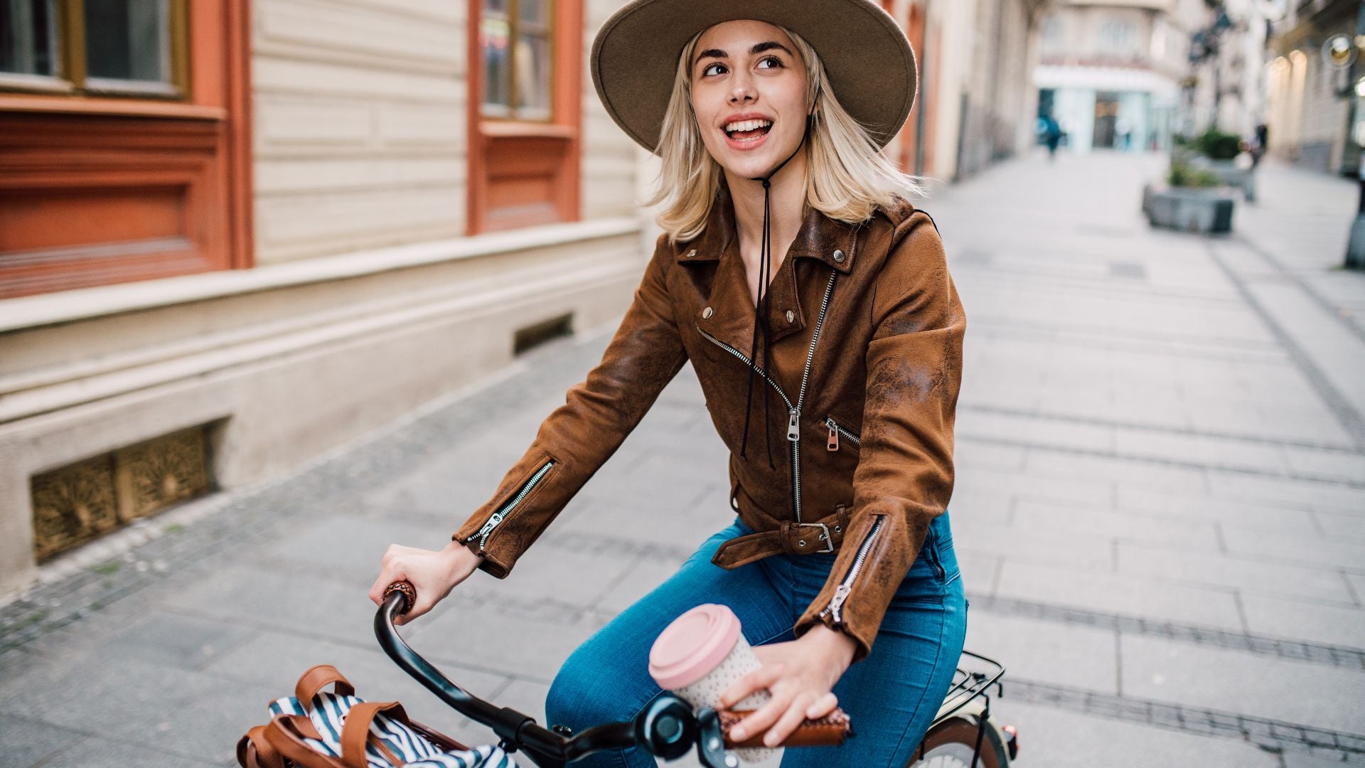 Girl on a bike wearing cowboy hat