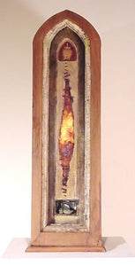 Sacrificial Temple. wood, oil, resin, Jimson Weed pod, mouse bones, light. 25″x7″x6,” 2000