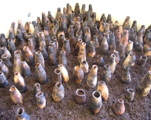 Vessels. smoke-fired clay, soil, light. dimensions vary, 2000