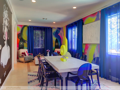 Fun modern airbnb with chic furniture and bright colored abstract wallpaper mural. Feature wall is covered with pop art.