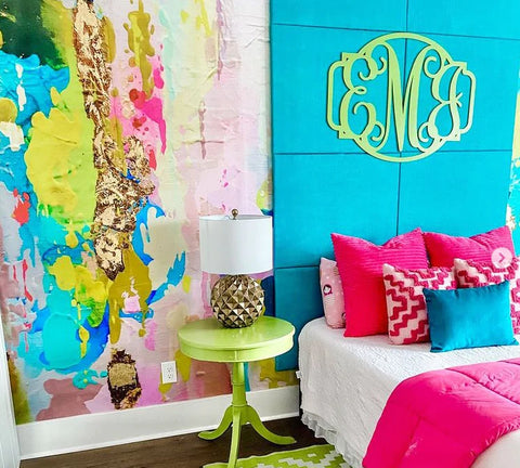 Teen bedroom with colorful abstract wallpaper, aqua headboard and pink pillows. This wallpaper mural is a great way to add color to any accent wall in an interior design project.
