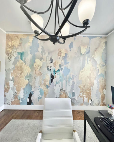 Home office interior design with blue, cream, gold wallpaper mural by Vivian Ferne. Chandelier and office chair sit at a desk.