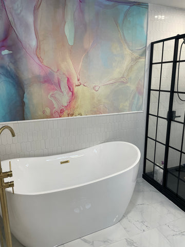 Bathroom decor concept with black and white fixtures, white tub and colorful marble textured wallpaper mural by Vivian Ferne.