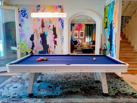 Game room pool and room decor with colorful abstract wallpaper mural and blue suede pool table.