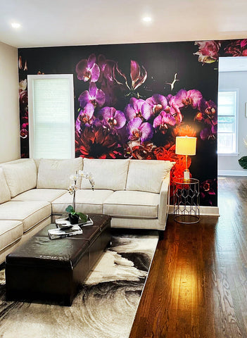 Beautifully cozy living room interior design concept with wrap around couch, hardwood flooring and large floral wallpaper mural.