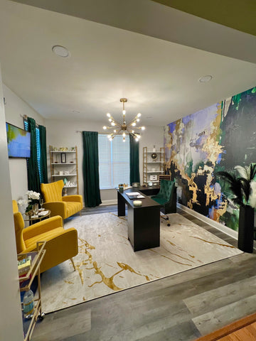 Home office interior design concept with large green abstract wallpaper mural from Vivian Ferne. Gold suede chairs, area rug and desk complete this home office look.