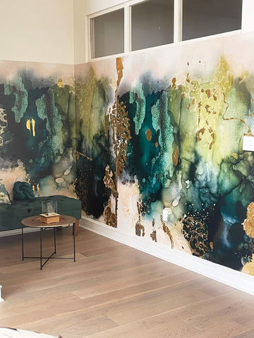 Office space interior design concept with bold, abstract wallpaper mural featuring greens, creams and real gold leaf textures. Designed by famous interior wall decor brand Vivian Ferne.