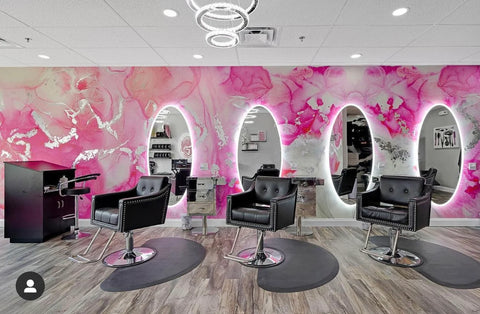 Hair Salon feature wall decor with large pink abstract wallpaper design by Vivian Ferne. Peel and stick wallpaper murals will make any salon stand out and provide a unique experience for customers