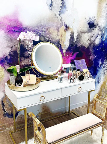 Teen bedroom with makeup table, gold and white desk and an abstract wallpaper mural. Abstract wallpaper mural is full of purples, grays and gold tones.