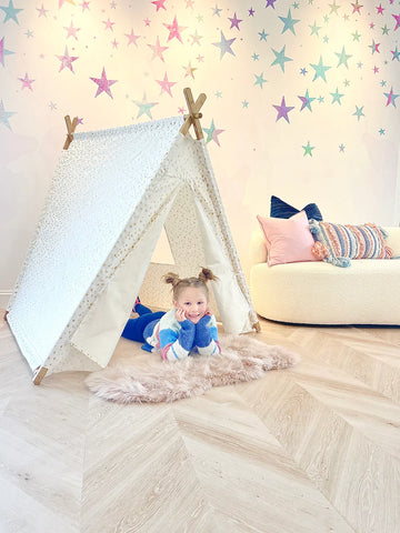 Kids activity room with interior kids tent, curved fluffy white couch and color wallpaper design with hand painted stars. Great DIY installation product available in Peel and Stick and Pre pasted - Kids decor to create stunning kids bedrooms and activity spaces.