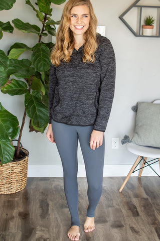 charcoal grey sweater paired with charcoal stirrup leggings