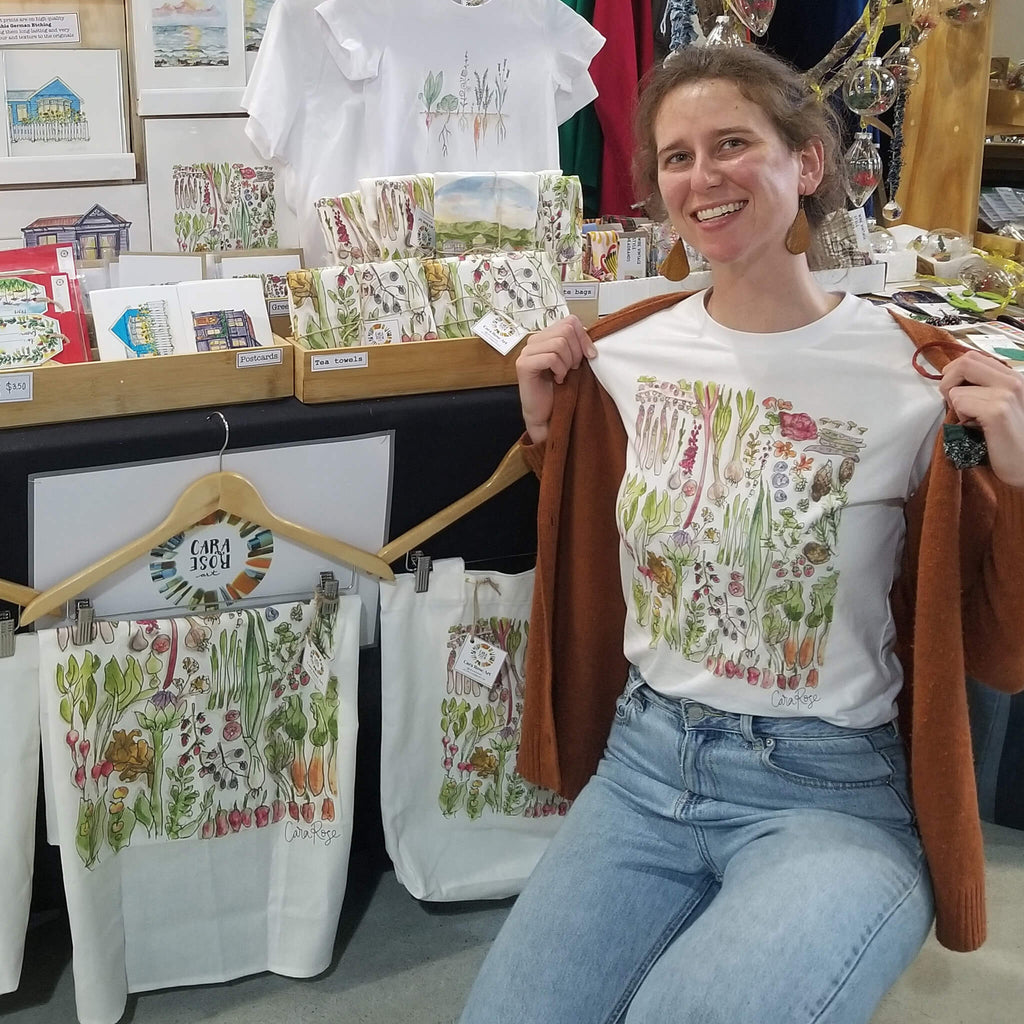 Discover the vibrant world of watercolours with Wellington artist Cara Brasted of Cara Rose Art, showcasing her talent at one of Wellington's bustling markets.