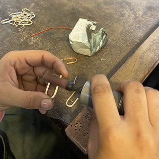 artisan making bombshell jewelry