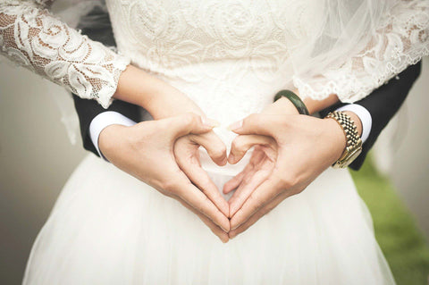 heart-shaped hands of couple wearing wedding rings dubai