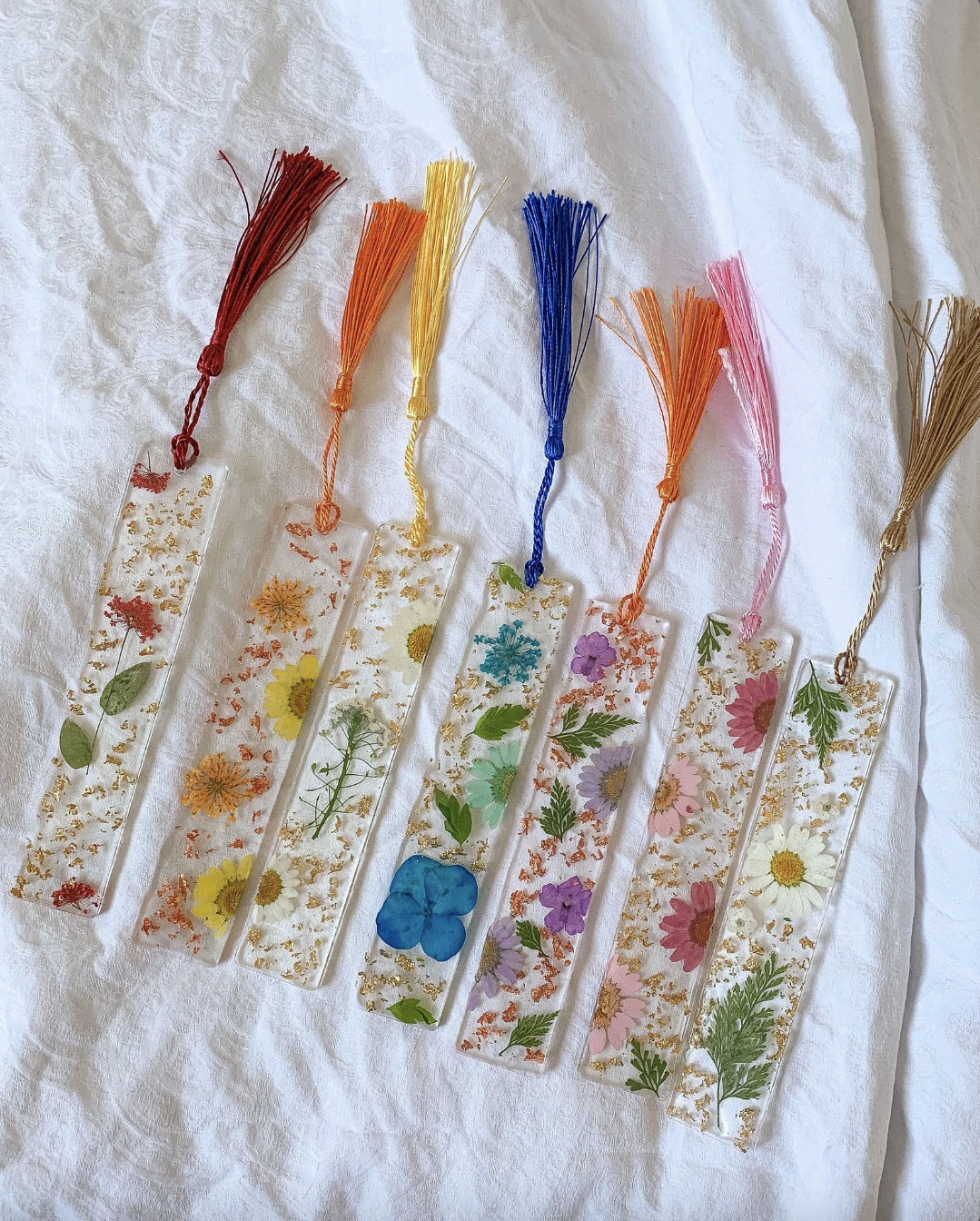 Seven different coloured bookmarks laid out in seven different colours.