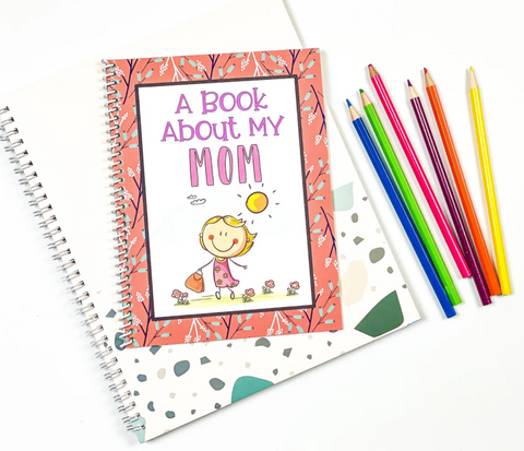 A book about my mom with a pencil crayons next to it.