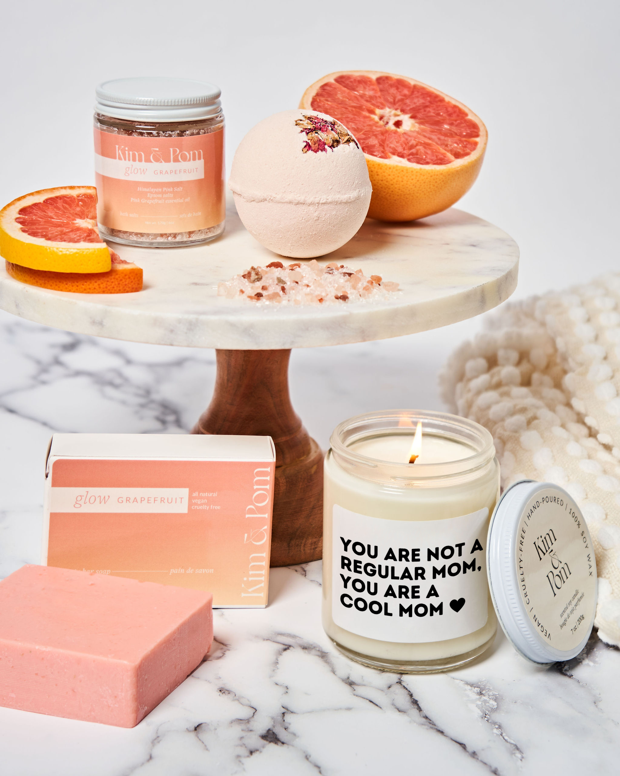 Pink Grapefruit gift box with a candle that has a label with text saying "You are not a regular mom, you are a cool mom".