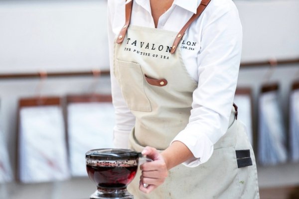 Woman Holding Tavalon Gravity Teapot | Tavalon Tea Australia