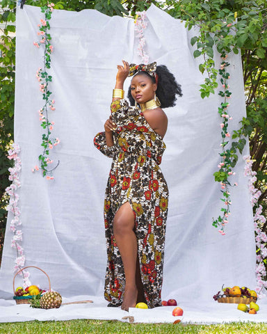 Pretty tall afro-american woman in a long dress and with curly hair  standing in a shopping mall Stock Photo - Alamy