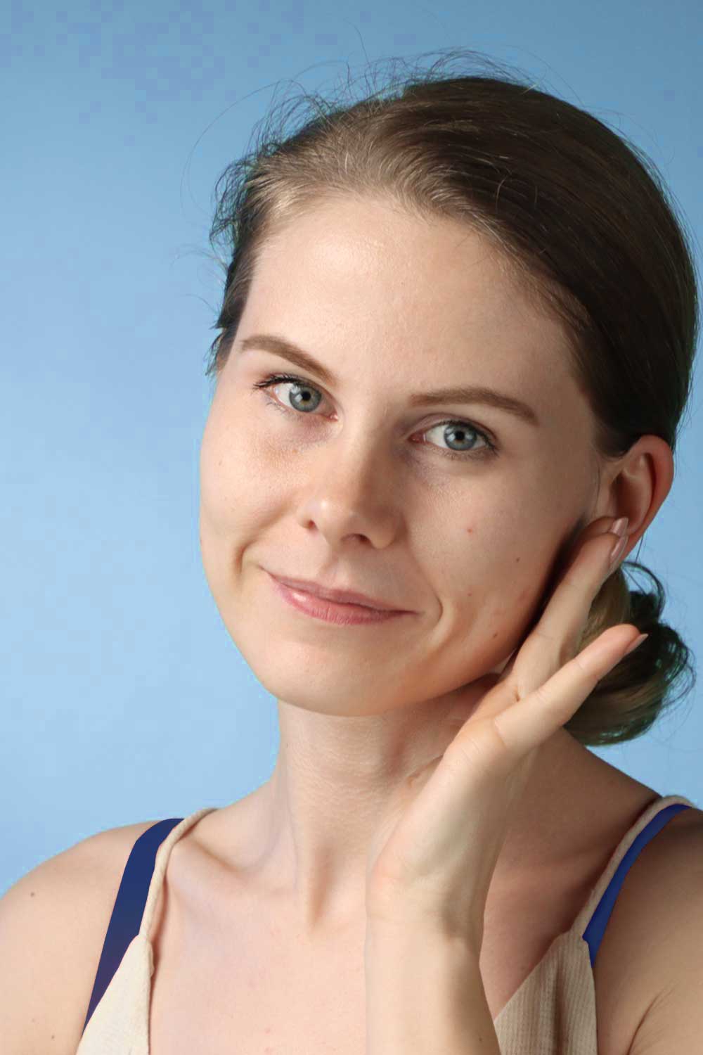 An image of a woman smiling as she lookes fresh