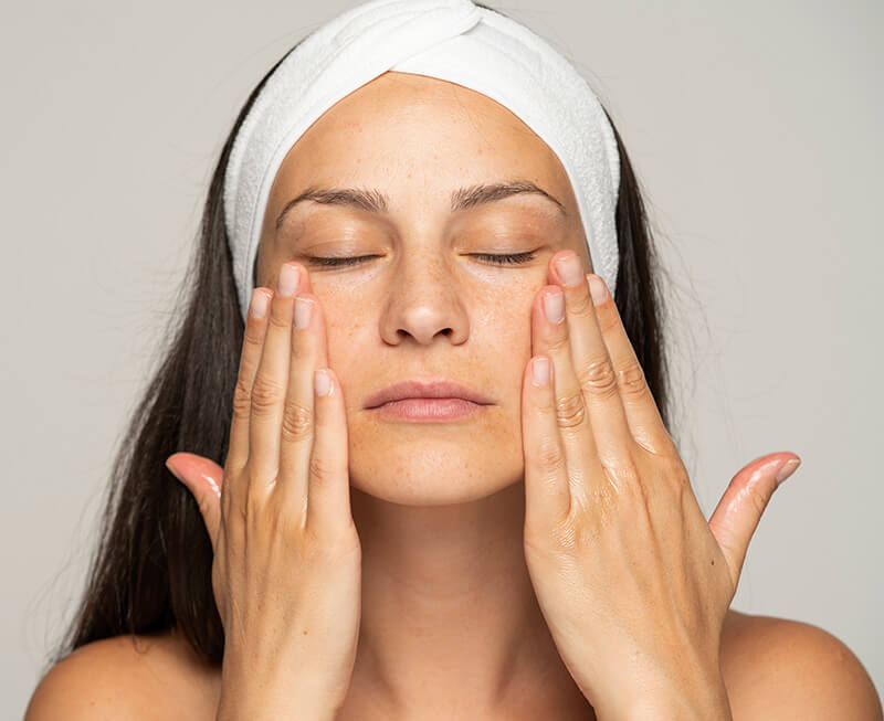 Woman massaging her face