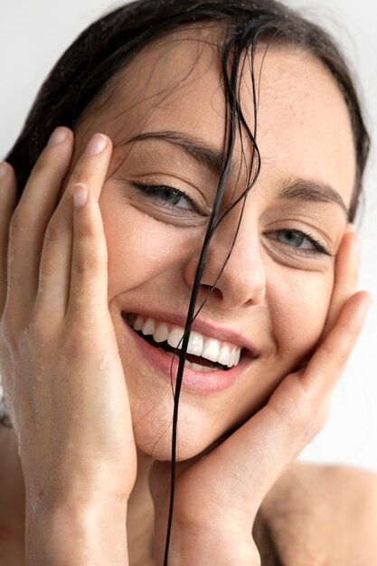 A woman touching her hydrating and moisturised face