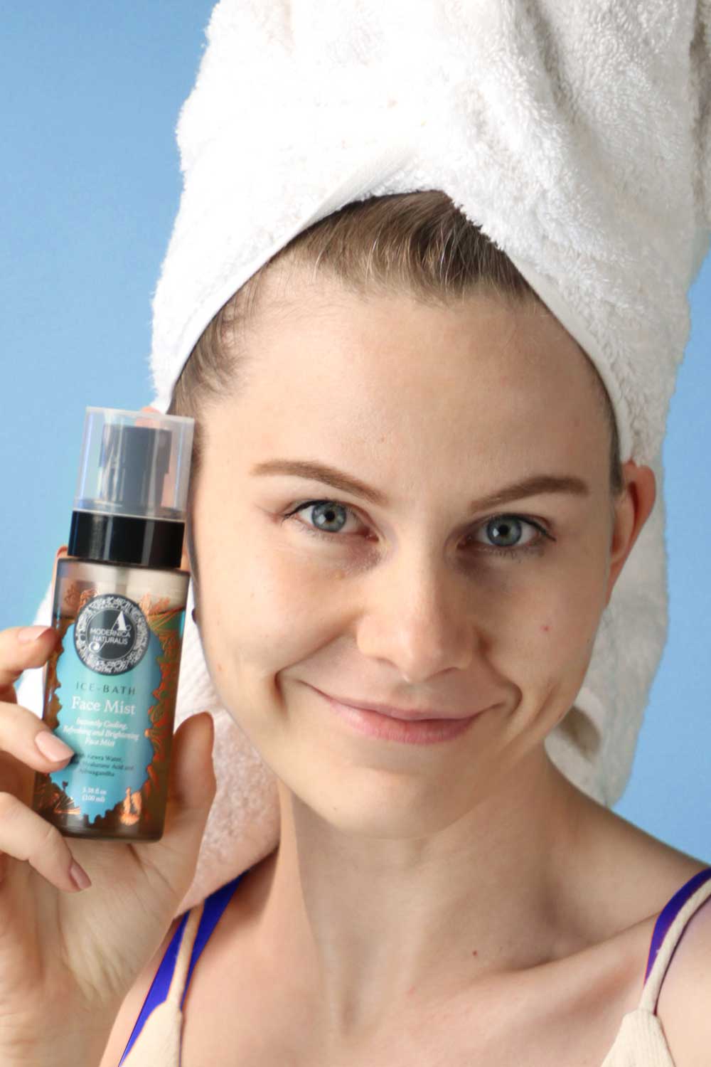 fresh faced woman holding Ice Bath Face Mist