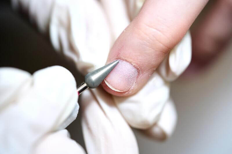 Drilling off the overlay nails and cuticles