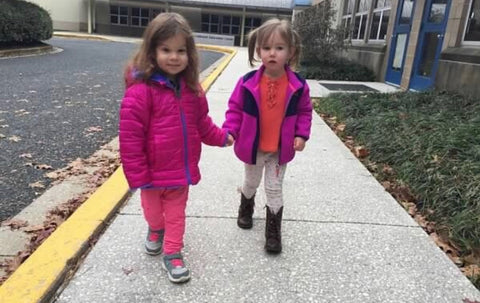 2 toddler girls walking holding hands