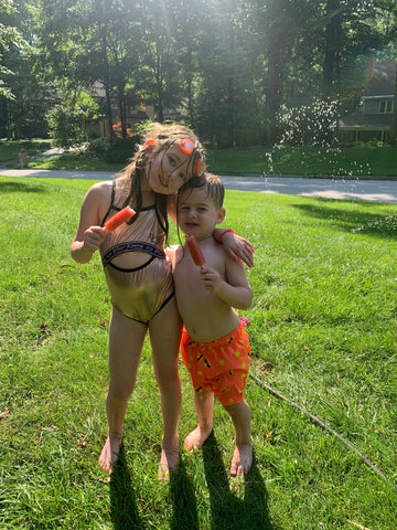 brother and sister eating popsicles.