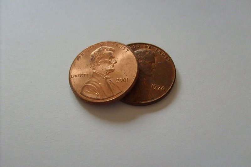 two pennies on blank background