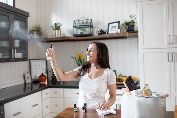 spritzing the air with essential oils for natural cleaning