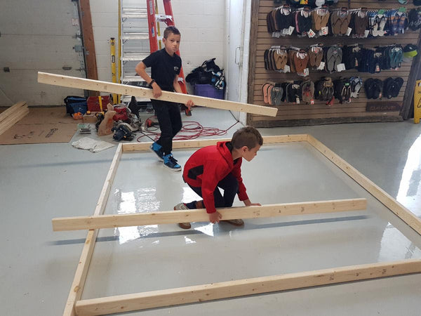 Youngsters learning how to frame for our re-purposed skid wall.