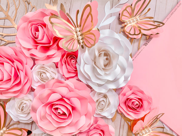 paper butterflies on a bed of pink paper roses