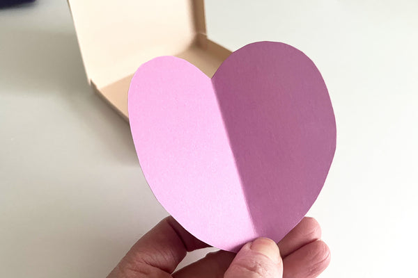 cutting a heart shape from paper