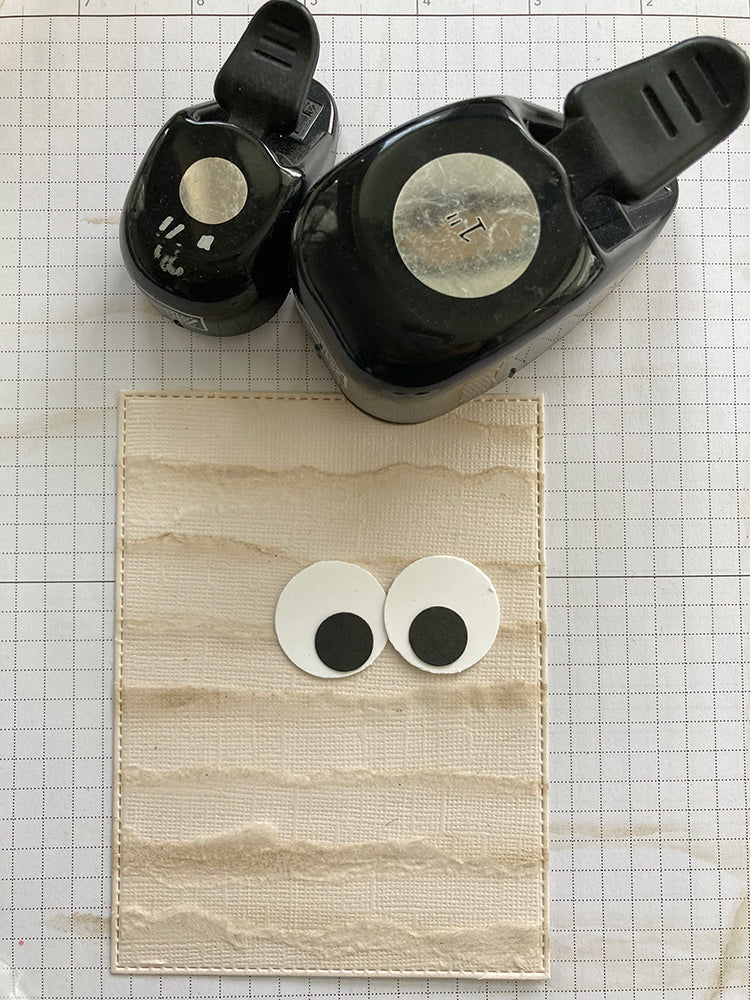layered cardstock mummy strips and circle punch eyeballs to make a mummy card