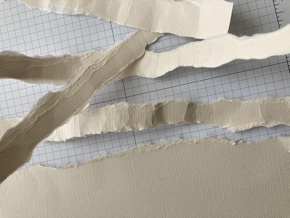 strips of torn cream cardstock