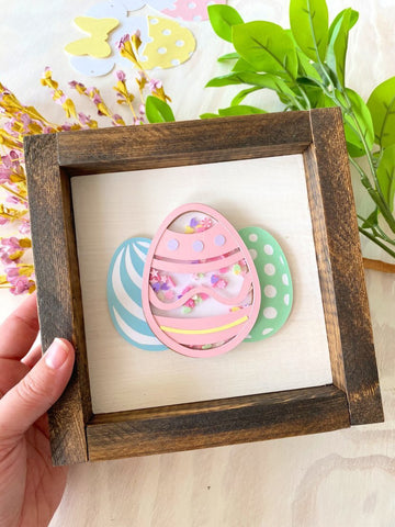 Paper Easter egg shaker mounted on a frame