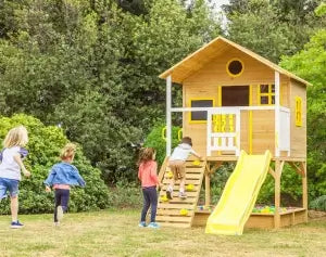 elevated cubby house in backyard with sandpit