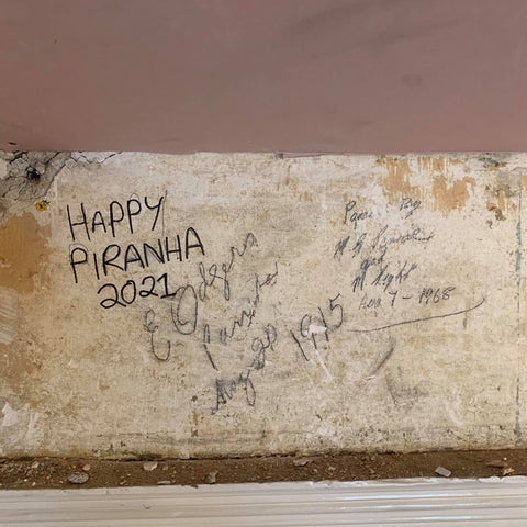 Notes left on a wall at the Happy Piranha building project from 1915 to 2021