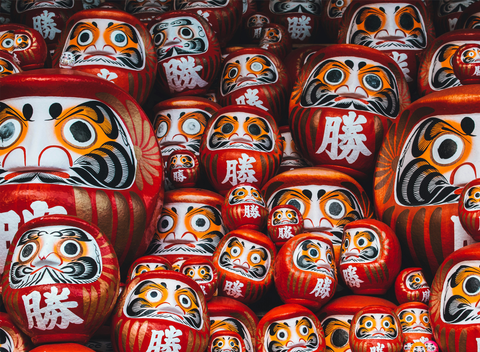 A big stack of red Daruma Dolls.