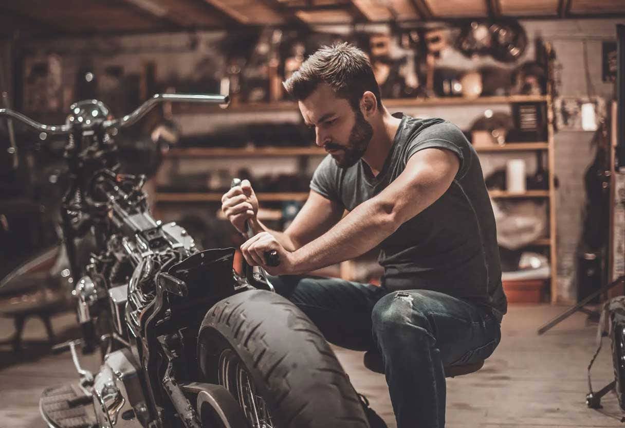 man changing a motorcycle tire