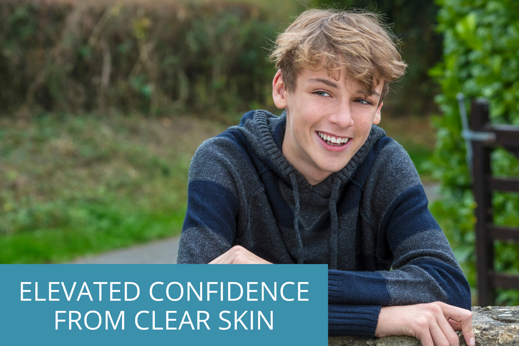 smiling teen boy with the overlay text saying elevated confidence from clear skin