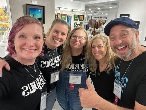 Khara Koffel, Lexy Determan, Megan Luckey, Whitney Schwartz and Howard Schwartz smile at the One of a Kind Show in Chicago