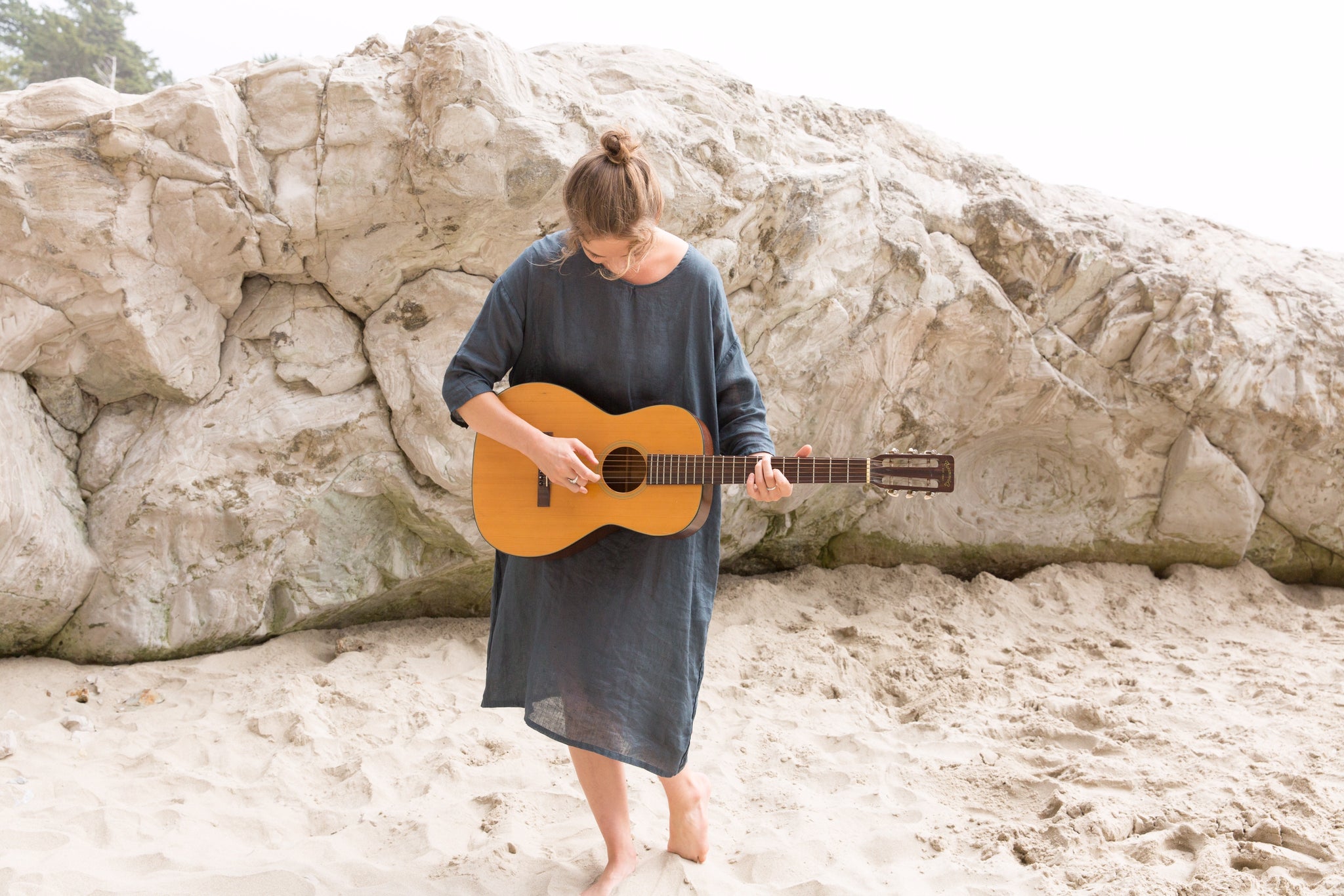 Portland musician, Hanna Haas, wearing CP Shades dress and playing guitar on beach